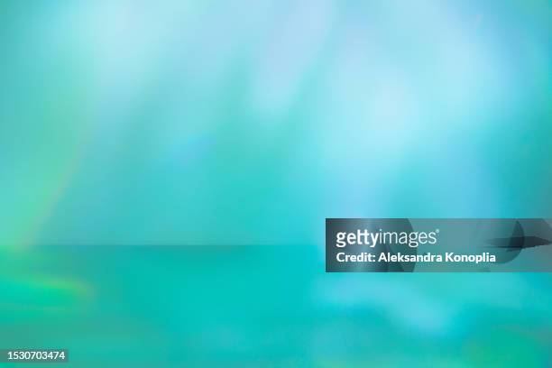 mint green, blue, purple colored display background with dreamy subtle lighting, water light refraction effect - turquoise stockfoto's en -beelden