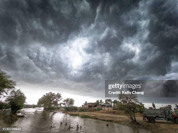 monsoon storm clouds over a river - monção imagens e fotografias de stock