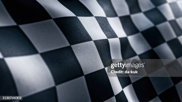 waving racing finish flag with checkered pattern texture in slow motion - checkered race flag stockfoto's en -beelden