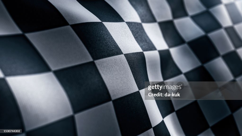 Waving Racing finish flag with checkered pattern texture in slow motion