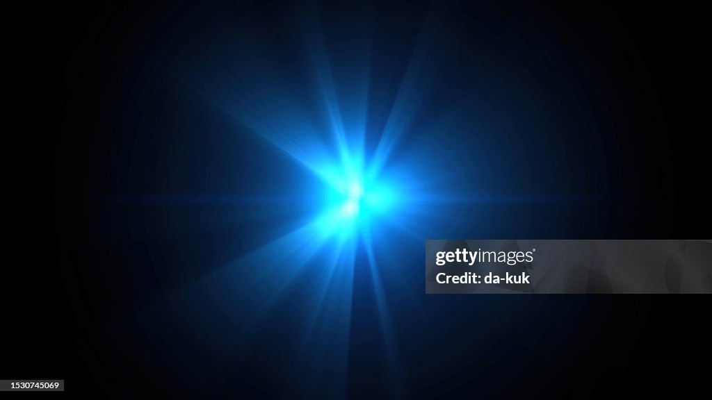 Blue lens flare on black background design element