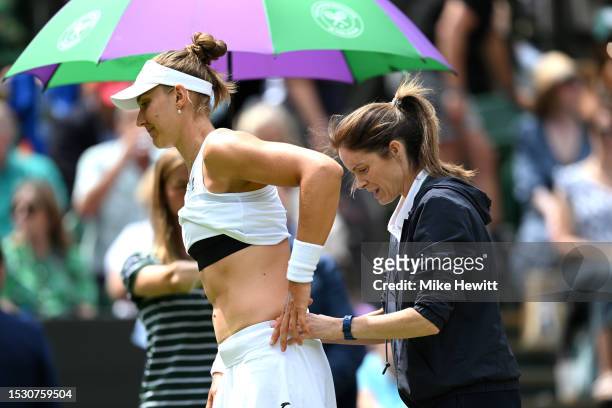 Beatriz Haddad Maia of Brazil receives medical treatment against Elena Rybakina of Kazakhstan in the Women's Singles fourth round match during day...