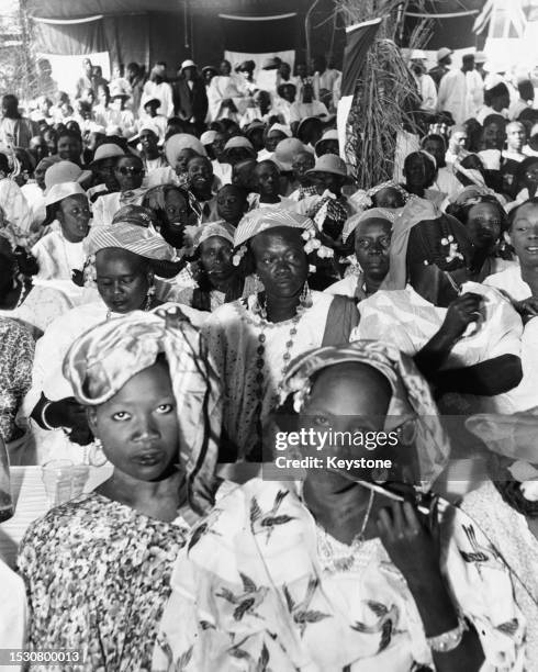 Senegalese women in a cafe, with men visible in the background, in Dakar, Senegal, circa 1955. Dakar is the capital of French West Africa, a...