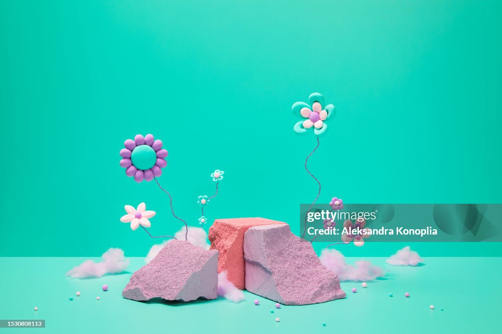 Abstract 3d stage with cute kawaii flowers, pink cotton candy and empty pastel purple and coral colored rocks podiums on green mint, turquoise, pink solid background with copy space