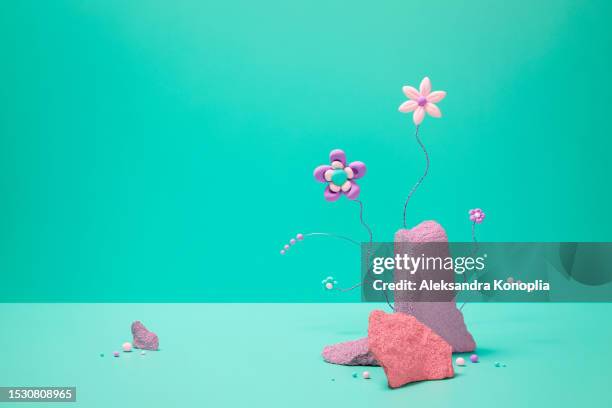 vibrant scene with three coral pink and purple rocks and whimsical kawaii flowers on turquoise green mint background in the style of minimalistic surrealism. abstract 3d stage with empty copy space. - mint green fotografías e imágenes de stock