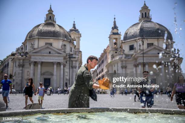 People cool off during an ongoing heat wave with temperatures reaching 40 degrees, at Piazza del Popolo, on July 10, 2023 in Rome, Italy.