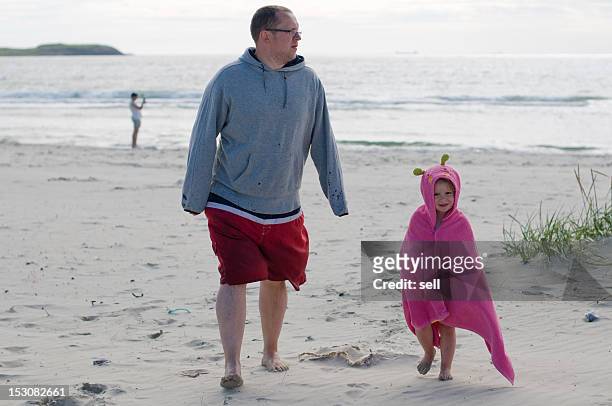 father and daughter at beach - stavanger stock-fotos und bilder