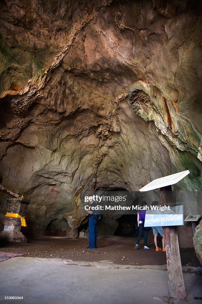 A tourist visits a cave.