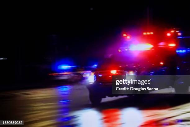 high speed pursuit - flashing lights on an ambulance - chasing stock pictures, royalty-free photos & images