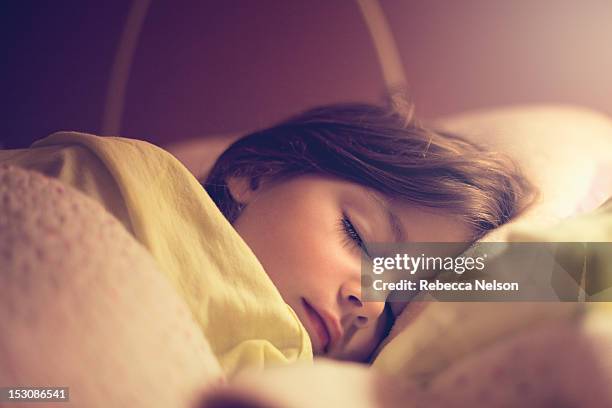 little girl sleeping in her bed - girl in her bed stock pictures, royalty-free photos & images