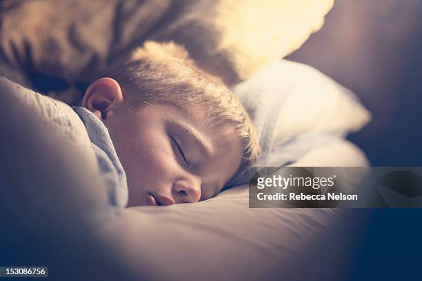 sleeping boy - boy asleep in bed stock pictures, royalty-free photos & images