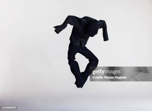 dressed human shape jumping in air - shirt no people stock-fotos und bilder