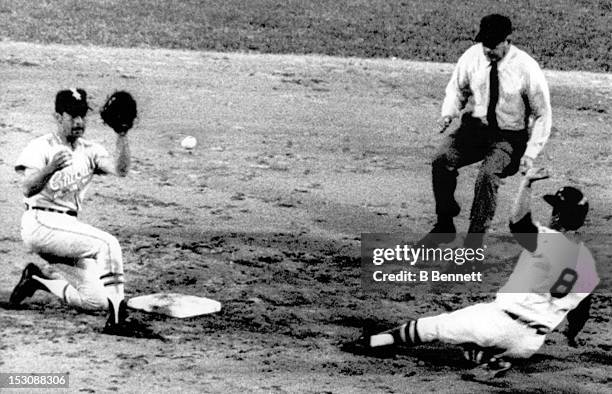 Carl Yastrzemski of the Boston Red Sox steals second base as Luis Aparico of the Chicago White Sox takes the throw as umpire Jim Odom moves into...