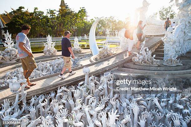 taking a tour of the famous white temple . - chiang rai province stock pictures, royalty-free photos & images