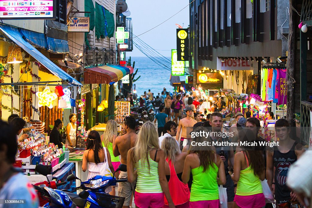 A busy street of neon clothed tourists.