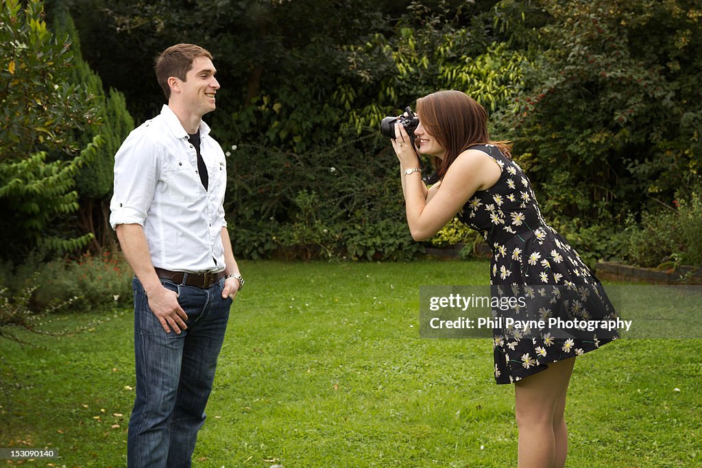 Woman taking photos of her boyfriend