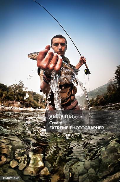 catching trout - freshwater fishing stock pictures, royalty-free photos & images