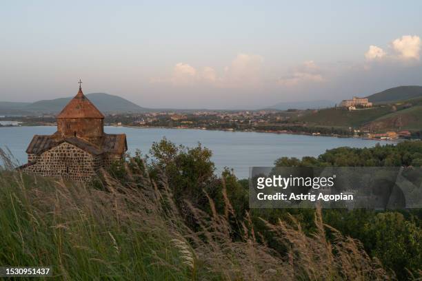 The Sevanavank monastery, which used to be on an island and now is on a peninsula as water decreased, overseeing Lake Sevan at dawn on July 8, 2023...