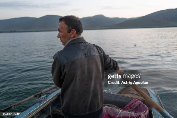 Local fisherman on his boat in the early morning on his way to fish for whitefish and trout on July 9, 2023 in Artanish, Armenia. Armenia's iconic...