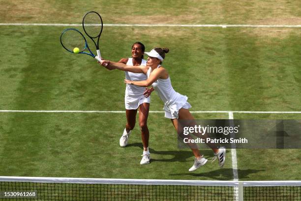 Naiktha Bains of Great Britain and partner Maia Lumsden of Great Britain compete for the same ball against Viktoria Hruncakova of Slovakia and Tereza...