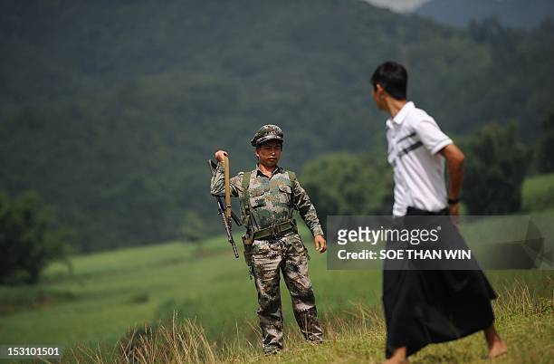 Myanmar-unrest-minorities,FOCUS' by Soe Than Win This picture taken on September 18, 2012 shows a Kachin Independence Army soldier patroling in Loije...