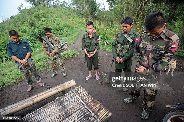 Myanmar-unrest-minorities,FOCUS' by Soe Than Win This picture taken on September 19, 2012 shows Kachin Independence Army soldiers praying before...