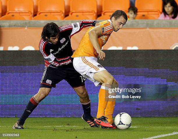 Cam Weaver of the Houston Dynamo keeps the ball away from Juan Toja of the New England Revolution in the second half at BBVA Compass Stadium on...