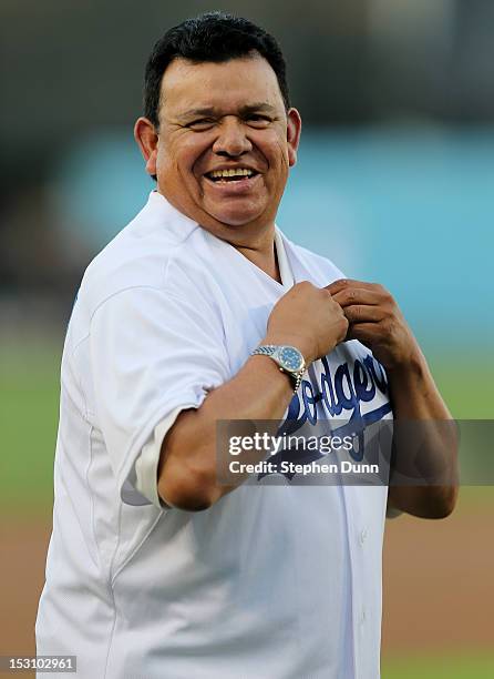 Former Dodger Hall of Fame pitcher and current Spanish language broadcaster Fernando Valenzuela laughs as puts on a Dodger jersey for pre game...