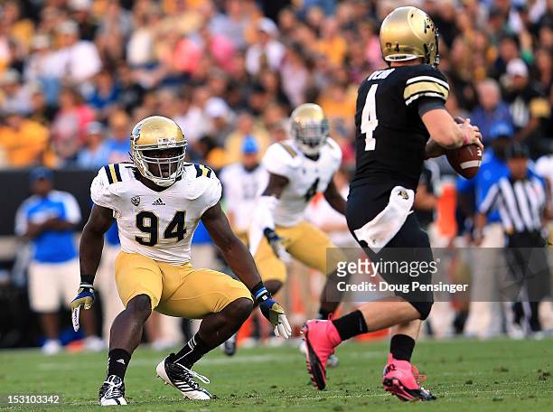 Defensive end Owamagbe Odighizuwa of the UCLA Bruins contains quarterback Jordan Webb of the Colorado Buffaloes at Folsom Field on September 29, 2012...