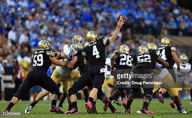 Quarterback Jordan Webb of the Colorado Buffaloes delivers a pass that is intercepted by by safety Stan McKay of the UCLA Bruins at Folsom Field on...