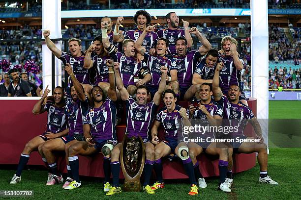 The Melbourne Storm celebrate on the podium after winning the 2012 NRL Grand Final match between the Melbourne Storm and the Canterbury Bulldogs at...
