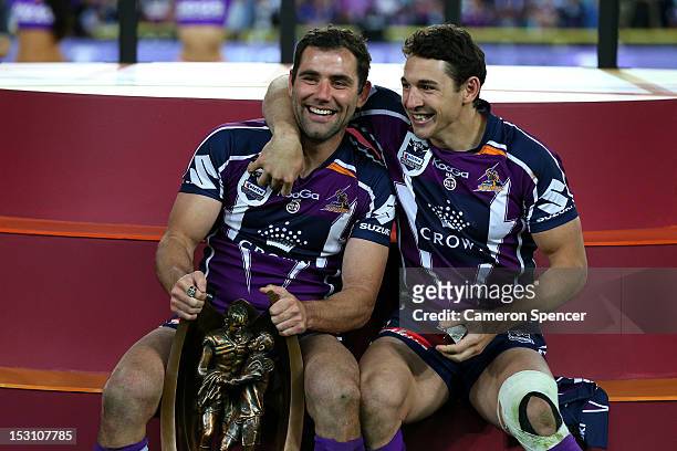 Cameron Smith and Billy Slater of the Storm celebrate on the podium after winning the 2012 NRL Grand Final match between the Melbourne Storm and the...