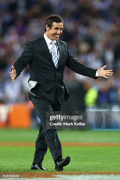 Former rugby league player Andrew Johns departs off a Black-Hawk helicopter at half-time during the 2012 NRL Grand Final match between the Melbourne...