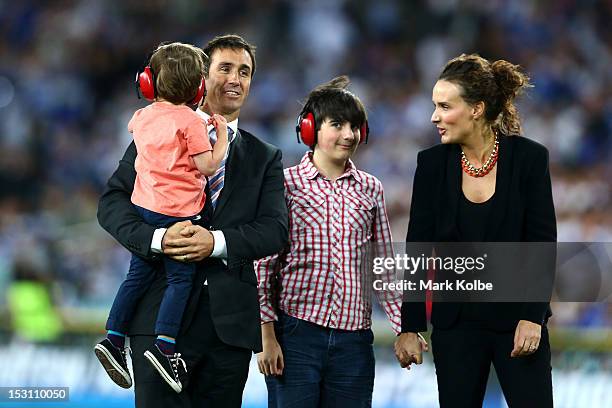 Former rugby league player Andrew Johns embraces his wife Cathrine Mahoney and his two son's Louis Byron and Samuel at half-time during the 2012 NRL...