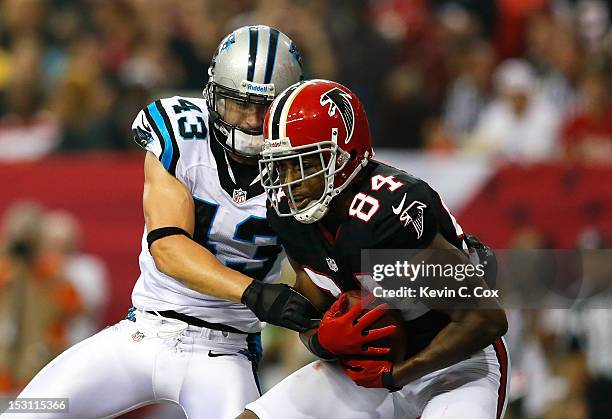 Roddy White of the Atlanta Falcons pulls in this touchdown reception against Haruki Nakamura of the Carolina Panthers at Georgia Dome on September...