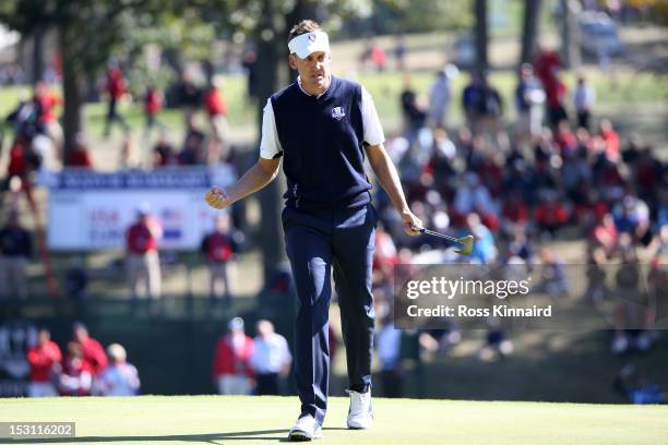 Ian Poulter of Europe celebrates a birdie putt on the 12th hole during the Singles Matches for The 39th Ryder Cup at Medinah Country Club on...