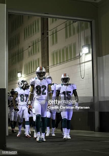 Wide receiver Brian Hartline of the Miami Dolphins leads teammates out onto the field before the NFL game against the Arizona Cardinals at the...