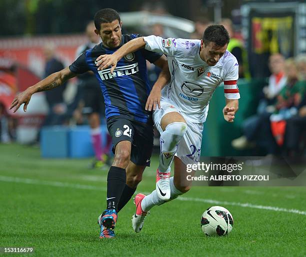 Fiorentina's defender Manuel Pasqual vies for the ball with Inter Milan's Uruguayan midfielder Alejandro Walter Gargano during their Serie A football...