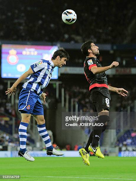 Espanyol's Argentinian defender Juan Forlin vies with Atletico Madrid's midfielder Raul Garcia during the Spanish league football match RCD Espanyol...