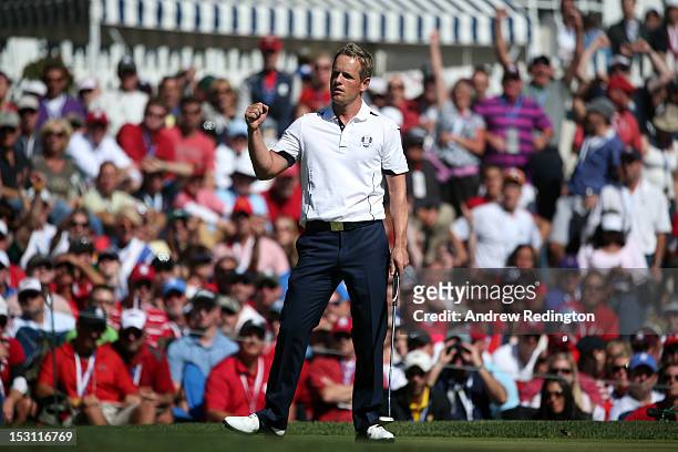 Luke Donald of Europe celebrates after saving bogey on the 13th green during the Singles Matches for The 39th Ryder Cup at Medinah Country Club on...