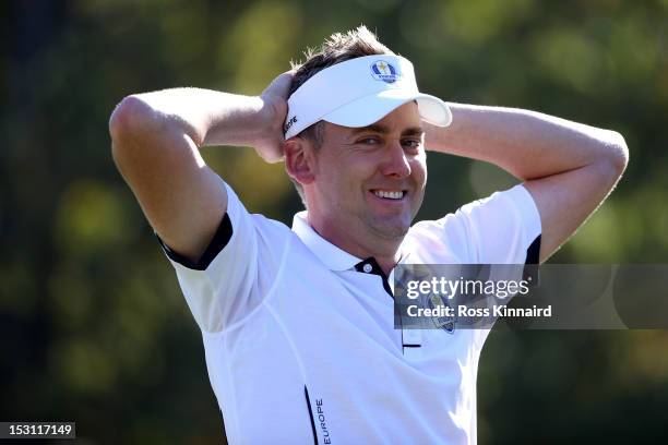 Ian Poulter of Europe waits on the 18th green after defeating Webb Simpson 2up during the Singles Matches for The 39th Ryder Cup at Medinah Country...