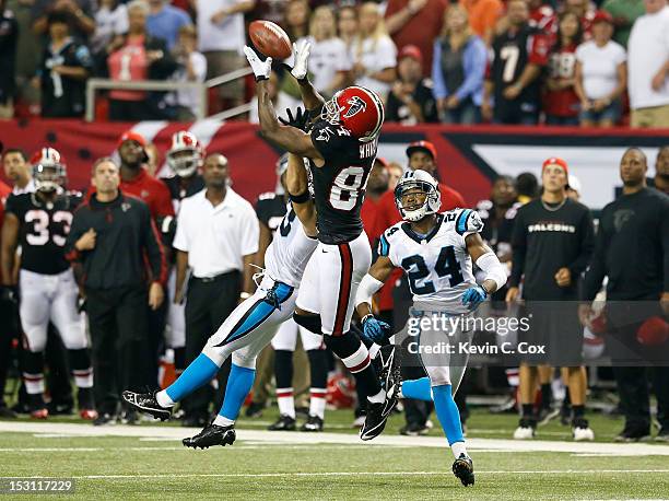 Roddy White of the Atlanta Falcons pulls in this reception against Haruki Nakamura and Josh Norman of the Carolina Panthers in the final seconds at...