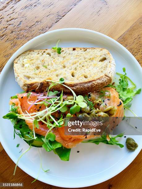 smoked salmon open sandwich with salad and garnish, on sourdough bread - sandwich bildbanksfoton och bilder