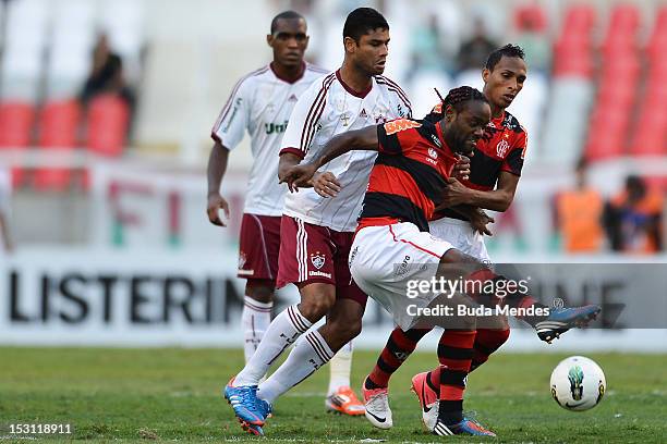 Gum of Fluminense struggles for the ball with Vagner Love and Liedson of Flamengo during a match as part of Serie A 2012 at Engenhao stadium on...