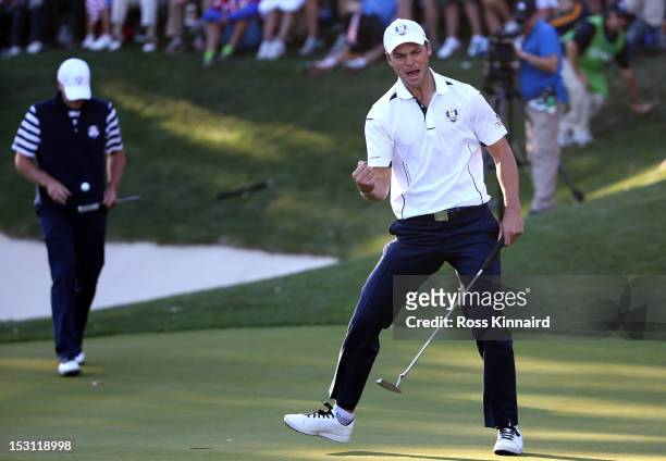 Martin Kaymer of Europe celebrates a par putt on the 17th green as Steve Stricker of the USA looks on during the Singles Matches for The 39th Ryder...