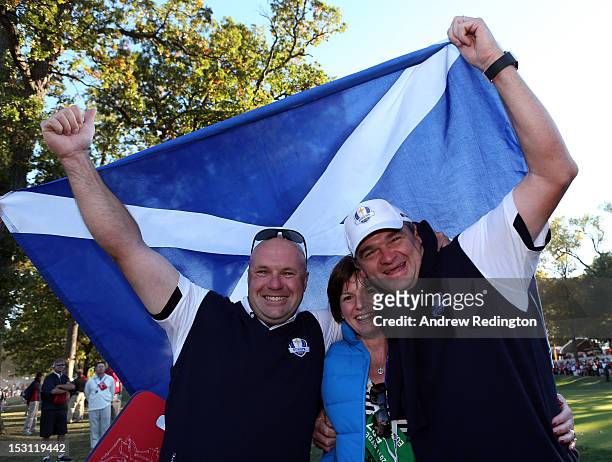 Paul Lawrie of Europe celebrates with his wife Marian and caddie David Kenny after Europe defeated the USA 14.5 to 13.5 to retain the Ryder Cup...