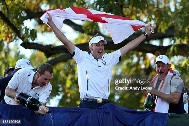 Ian Poulter, John McLaren and Lee Westwood of Europe celebrate after Europe defeated the USA 14.5 to 13.5 to retain the Ryder Cup during the Singles...