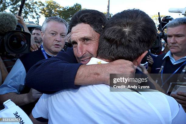 Team captain Jose Maria Olazabal hugs Francesco Molinari after Europe defeated the USA 14.5 to 13.5 to retain the Ryder Cup during the Singles...