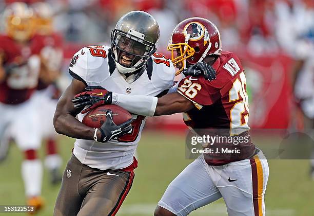 Receiver Mike Williams of the Tampa Bay Buccaneers is tackled by defender Josh Wilson of the Washington Redskins during the game at Raymond James...