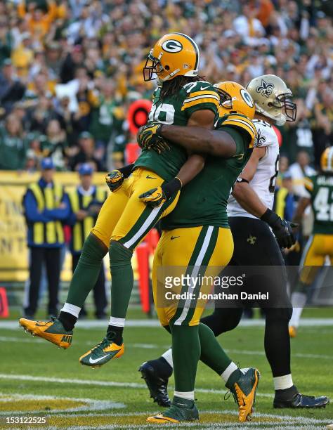 Raji of the Green Bay Packers lifts up Tramon Williams after a defensive stop against the New Orleans Saints at Lambeau Field on September 30, 2012...
